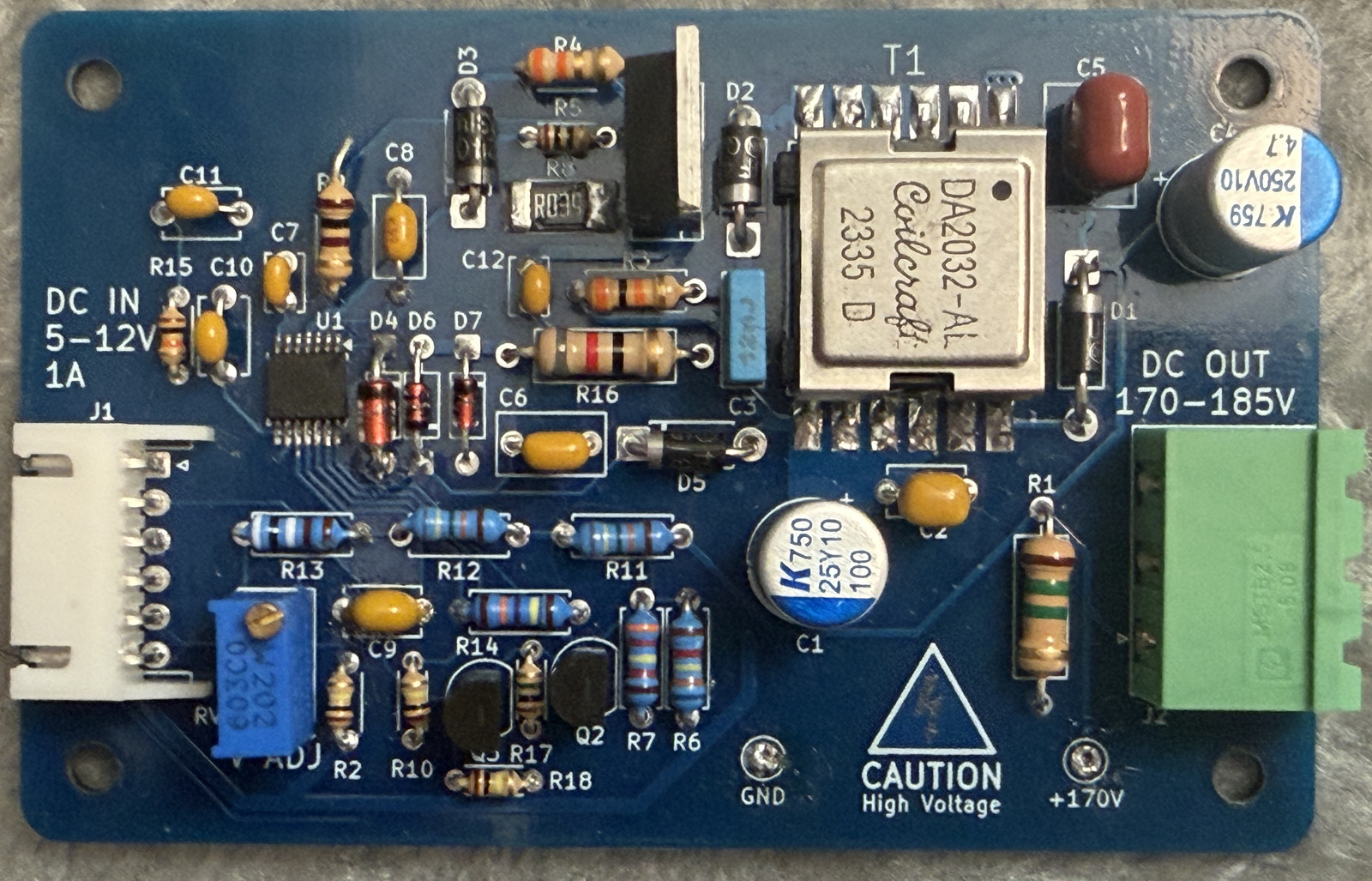 A blue circuit board featuring a large transformer and associated control circuitry